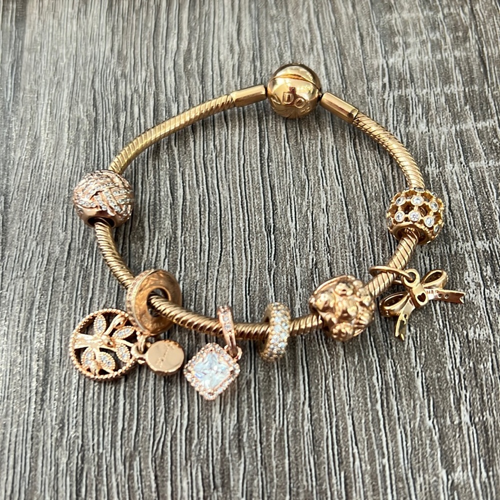 Pandora rose gold plated bracelet and 7 charms